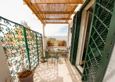 a balcony with a table and chairs on it at Stunning 3-Bedroom Penthouse in Rome