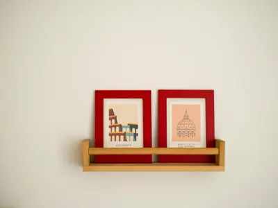 a shelf with three pictures of different buildings at Stunning 3-Bedroom Penthouse in Rome