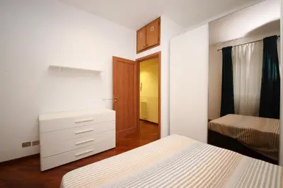 a bedroom with two beds and a dresser in it at Yellowmat by Ghor in Rome