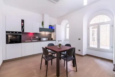 a kitchen and dining room with a table and chairs at JOIVY Cavour 238 in Rome