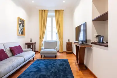 a living room with a couch and a tv at Elegant Salandra Suite in Rome