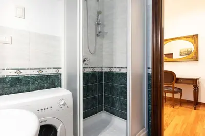 a bedroom with three beds and a window at Elegant Salandra Suite in Rome