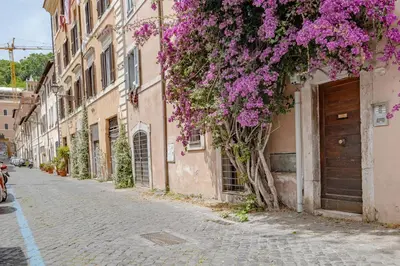 an alley with purple flowers on a building at Apartment B5 in the center of Rome WiFi and AC in Rome