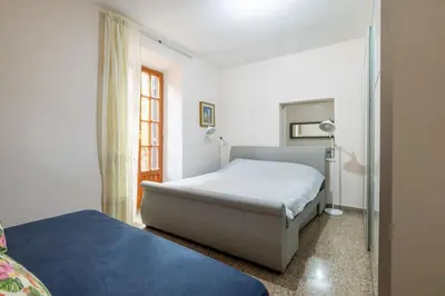 a bedroom with a bed and a window at Residenza Latina -Charme & Relax in Rome