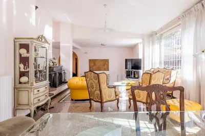 a living room with a glass table and chairs at Residenza Latina -Charme & Relax in Rome