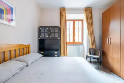 a bedroom with a bed and a chair and a window at Residenza Latina -Charme & Relax in Rome
