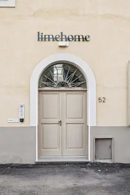 a door to a building with a sign above it at Limehome Rome Via Fortebraccio in Rome