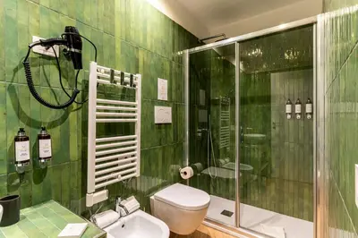 a bedroom with a large bed and a mirror at Urban Vatican Rooms in Rome