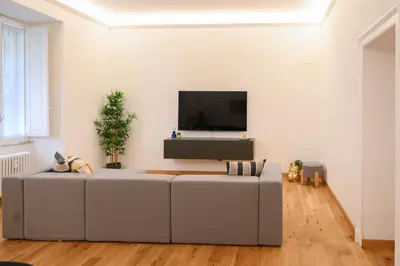 a living room with a couch and a flat screen tv at Ferrari 12 Apartment - Vaticano in Rome