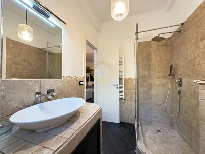 a bathroom with a white sink and a shower at Casa Vacanze Secret Garden in Rome
