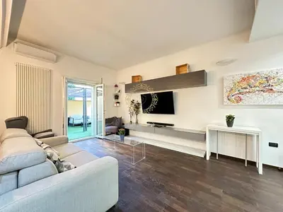 a living room with a couch and a tv at Casa Vacanze Secret Garden in Rome