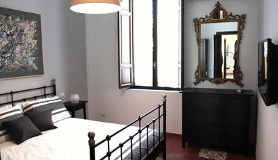a bedroom with a bed and a mirror on the wall at Borgo Pio Holiday in Rome