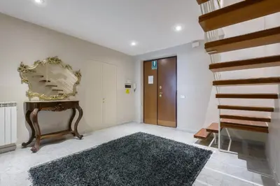 a hallway with a staircase and a mirror on the wall at Navona New Deluxe Apartment in Rome