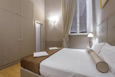 a bedroom with a large bed with two towels on it at Navona New Exclusive Apartment in Rome