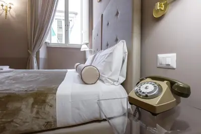 a room with a bed with a phone on it at Navona New Exclusive Apartment in Rome