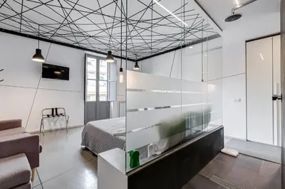 a bedroom with a bed and a glass wall at The Upper Suites in Rome