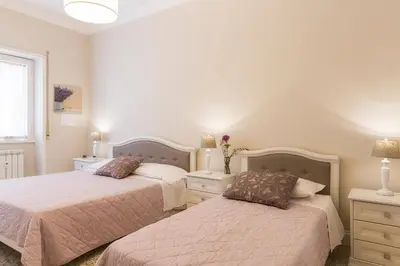a bedroom with two beds and a window at Aurora Guest House in Rome