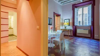 a dining room with a white table and chairs in a room at EasyTopStay - Campo de' Fiori Pinky House in Rome