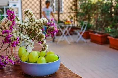 a bowl of apples and flowers on a table at Milvio22 Apartment in Rome