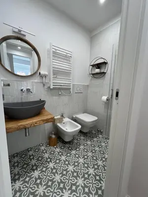 a bathroom with a sink and a toilet and a mirror at dAngelo Apartment Vatican Rome in Rome