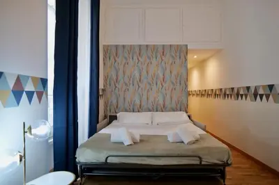 a bedroom with a bed with two towels on it at Livia86 - Trastevere in Rome
