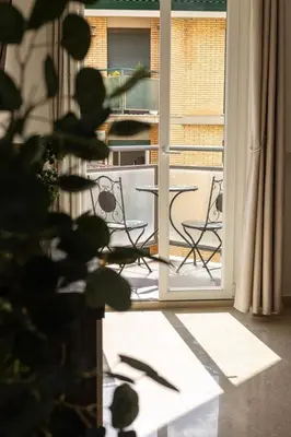 an open door to a patio with a table and chairs at La Bellavita Trastevere in Rome