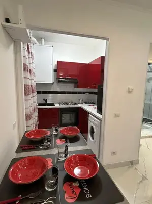 a kitchen with red plates on a stove top at Casa vacanze Flaminia in Rome