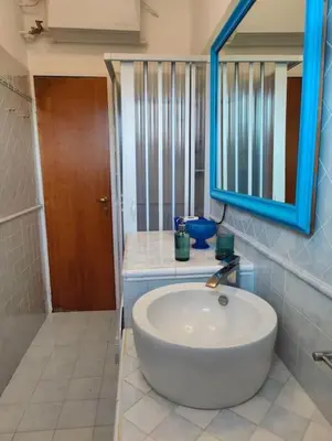 a bathroom with a white sink and a blue mirror at Culla di Diego BOX auto, Sospesi nel Cielo! in Rome