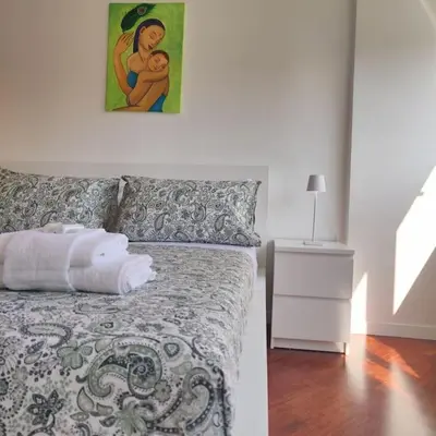 a bedroom with a bed with a painting on the wall at Culla di Diego BOX auto, Sospesi nel Cielo! in Rome