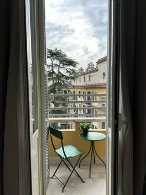 a room with a window with a table and a chair at Domus house in Rome