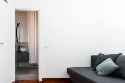 a living room with a couch and a bathroom at B&D Dolce Vita in Rome