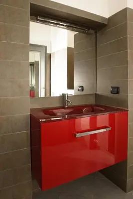 a bathroom with a red sink and a mirror at B&D Dolce Vita in Rome