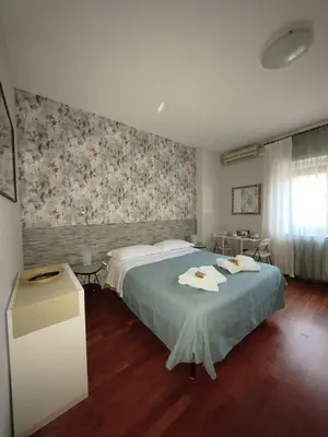 a bedroom with a bed with towels on it at Gregory B&B Vatican in Rome