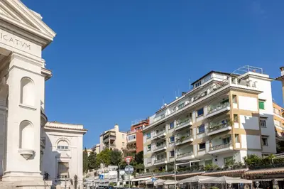 a tall white building in a city with buildings at LaDolcevita - Ponte Milvio Stunning View Penthouse in Rome