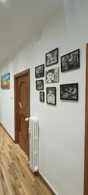 a room with a wall with pictures on it at Viale dei Re di Roma in Rome