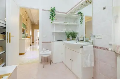 a white bathroom with a sink and a toilet at Royal Vatican house JND in Rome