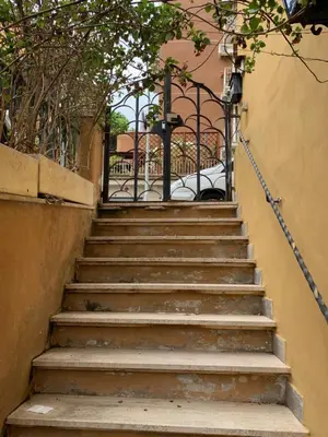 a set of stairs leading up to a gate at San Giovanni Loft in Rome