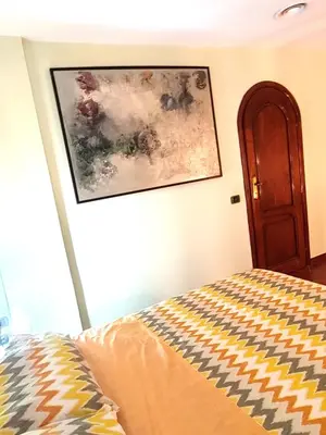 a bedroom with a painting on the wall and a bed at San Giovanni Loft in Rome