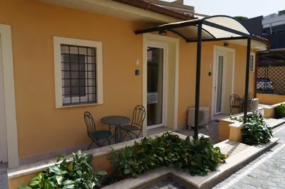 a patio of a house with a table and chairs at Gemelli BnB Guest House in Rome