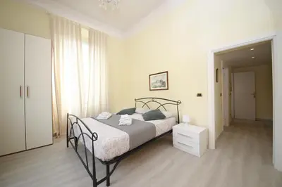 a bedroom with a bed in a white room at Rafael House by GHOR in Rome