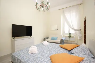 a bedroom with a bed with a flat screen tv at Rafael House by GHOR in Rome