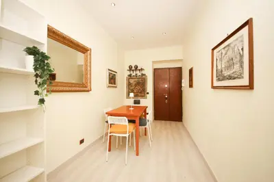 a dining room with a table and a mirror at Rafael House by GHOR in Rome