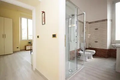 a bathroom with a glass shower and a toilet at Rafael House by GHOR in Rome
