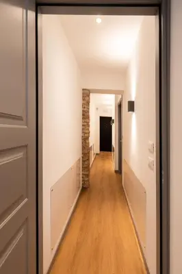 a hallway with a brick wall and a door at Trevi Monti House in Rome