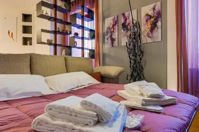 a bedroom with a bed with towels on it at Belli Vatican Attico - Luxury Design Rooftop Apartment close to Vatican City in Rome