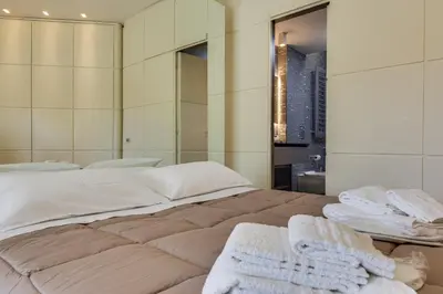 a bedroom with a large bed with towels on it at Belli Vatican Attico - Luxury Design Rooftop Apartment close to Vatican City in Rome