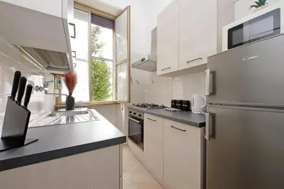 a kitchen with a sink and a refrigerator at MAYA - Boutique Apartment in Rome