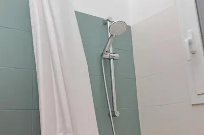 a shower with a shower head in a bathroom at MAYA - Boutique Apartment in Rome