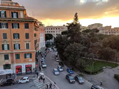 a city street with cars parked on the street at L'Ottavo Re di Roma in Rome