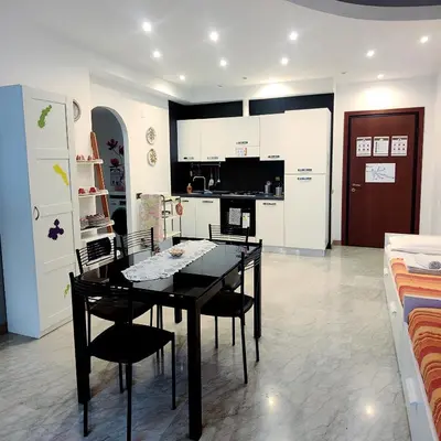 a kitchen with a table and chairs in a room at Roma For You - Apartment - Metro B in Rome